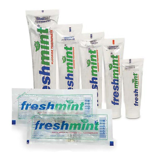 Several tubes and packets of Freshmint fluoride toothpaste are arranged in a group.
